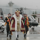 The oppressive bourgeoise lord and his royal guard are escorted from his palace by the proletariat.